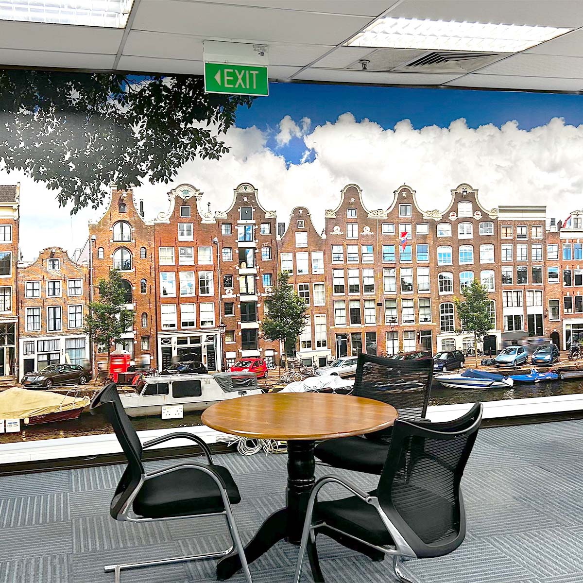 Office with Amsterdam canal wallpaper, round table, and chairs,